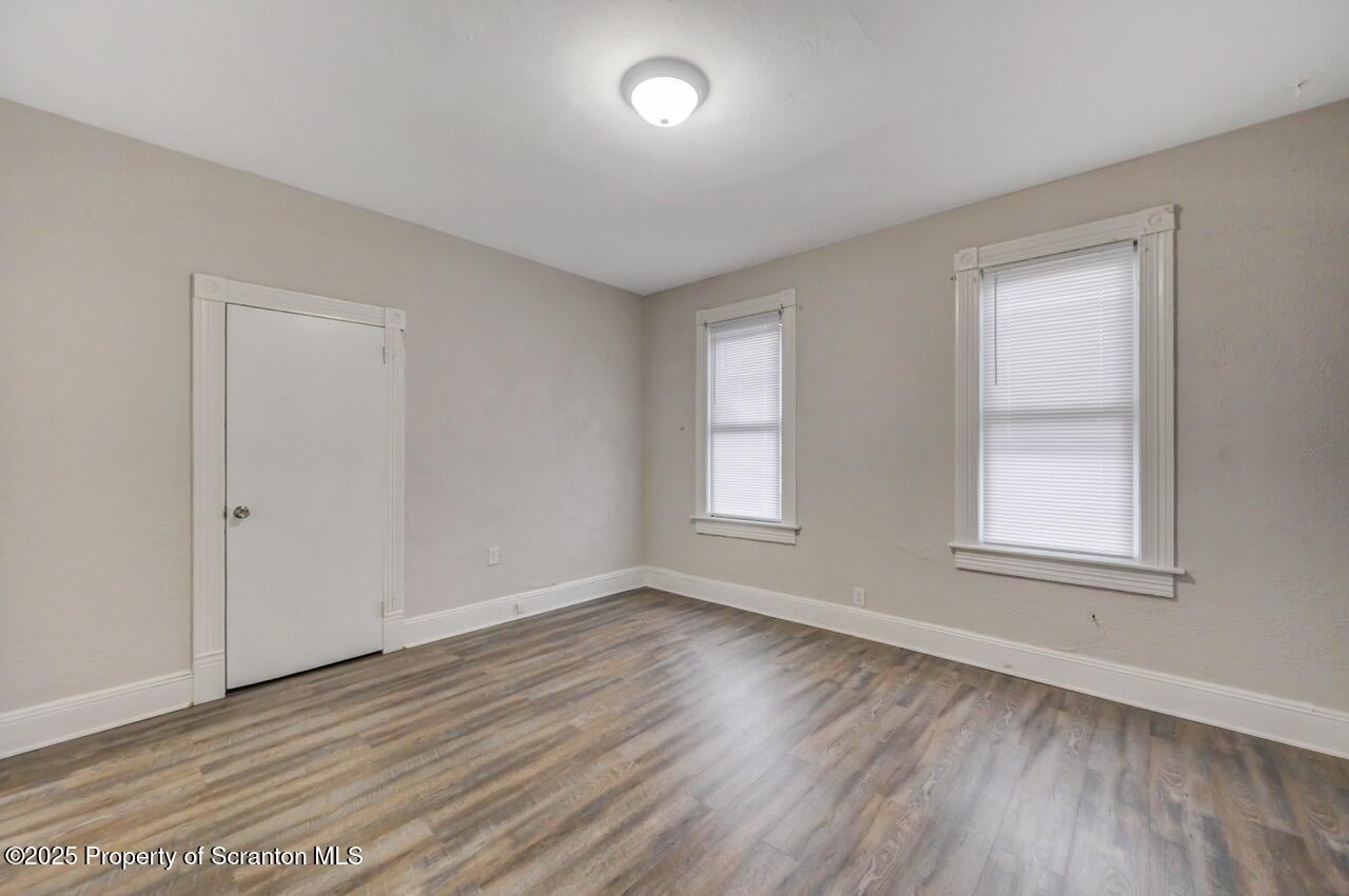 516 Harrison Avenue Scranton, PA 18510 - Photo 7 of 74 an empty room with wooden floor and windows