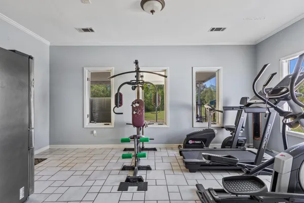 a room with gym equipment and large mirror