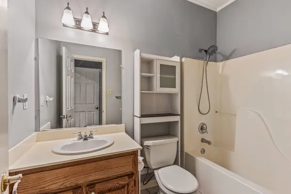 a bathroom with a sink toilet a mirror and shower