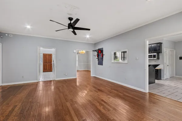 a view of empty room with wooden floor