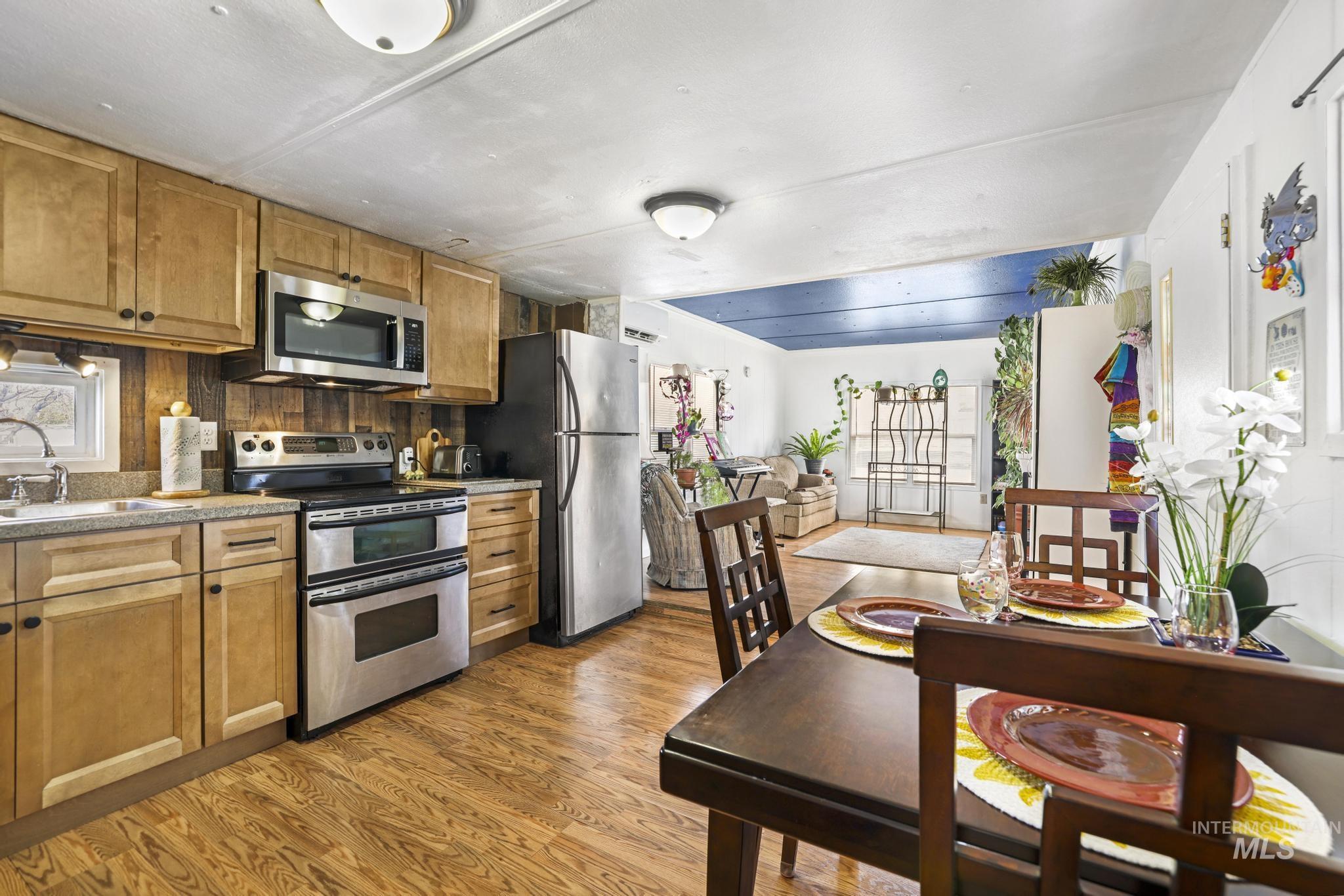 198 South Hills Road, Unit 45 Twin Falls, ID 83301 - Photo 14 of 25 Kitchen featuring stainless steel appliances, dark wood finished floors, and wood finish cabinetry
