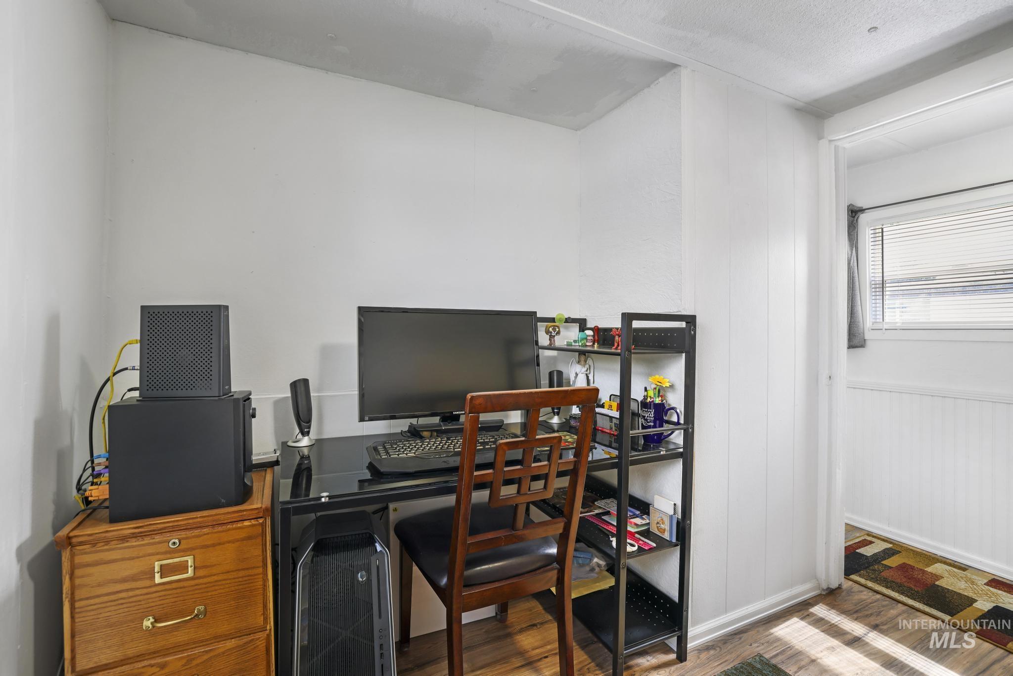 198 South Hills Road, Unit 45 Twin Falls, ID 83301 - Photo 16 of 25 Home office featuring wood finished floors and a wainscoted wall
