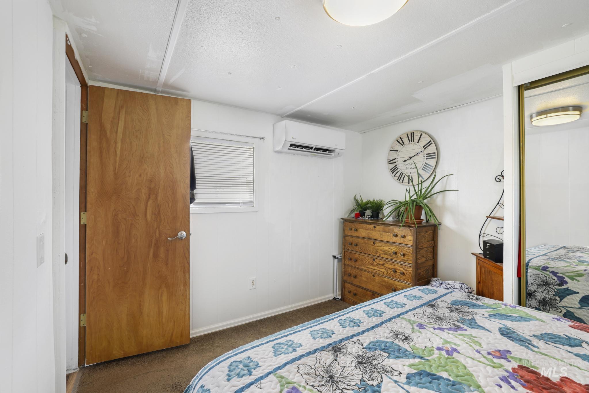 198 South Hills Road, Unit 45 Twin Falls, ID 83301 - Photo 19 of 25 Bedroom with dark colored carpet and a mini split for heating / cooling