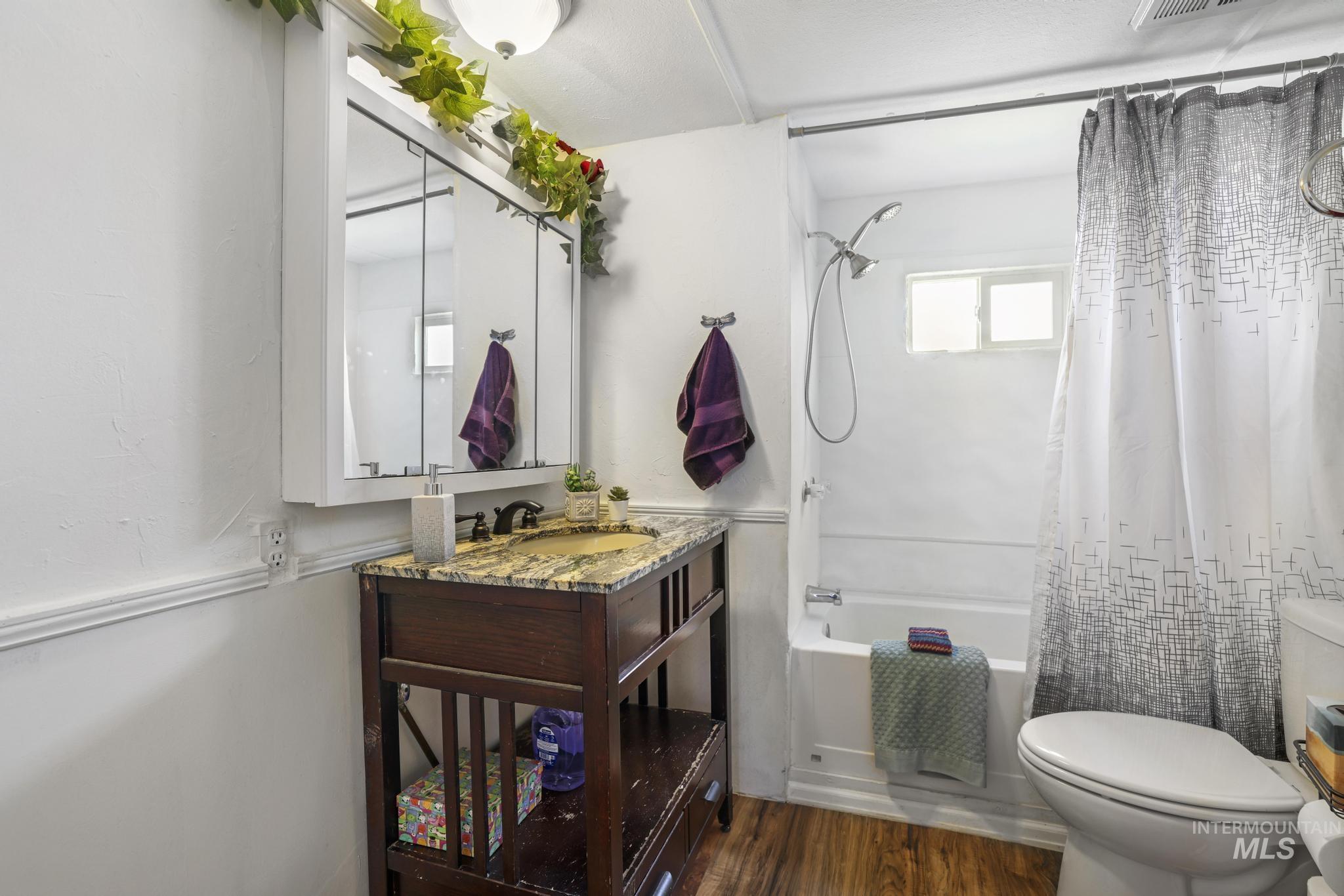 198 South Hills Road, Unit 45 Twin Falls, ID 83301 - Photo 21 of 25 Full bathroom with shower / tub combo with curtain, dark wood-type flooring, and vanity