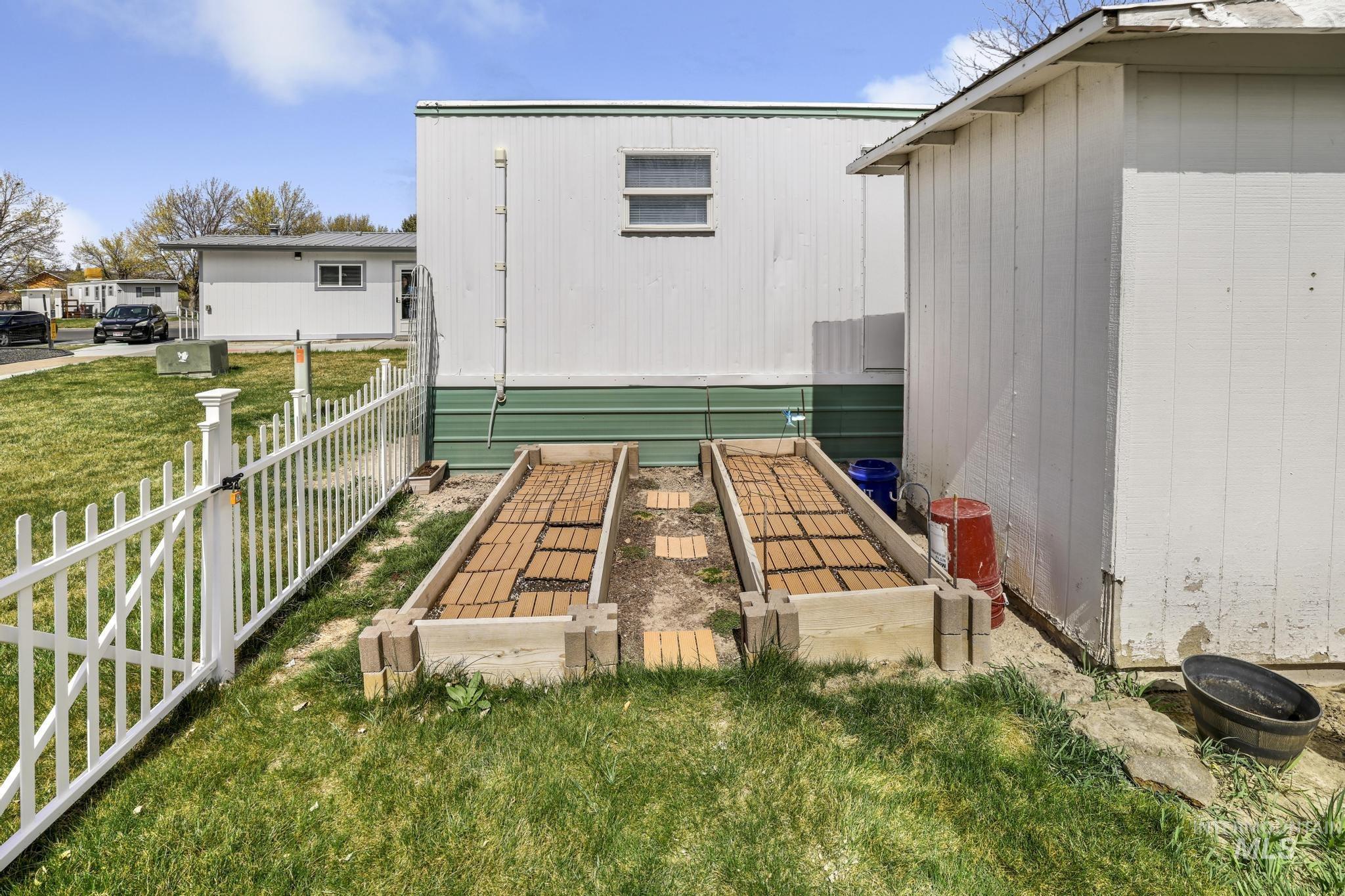 198 South Hills Road, Unit 45 Twin Falls, ID 83301 - Photo 23 of 25 View of yard with a garden and a storage unit