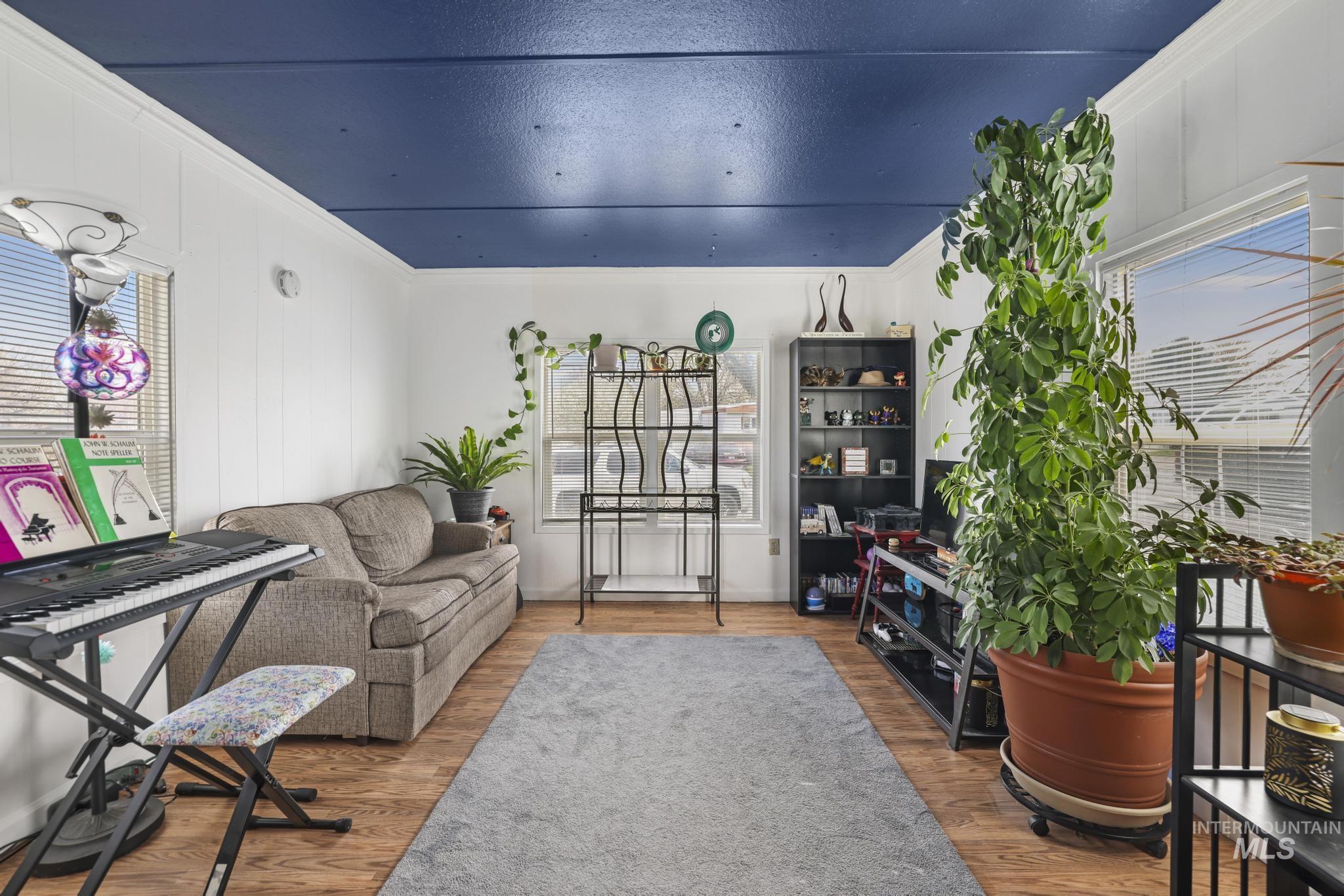 198 South Hills Road, Unit 45 Twin Falls, ID 83301 - Photo 6 of 25 Living area featuring wood finished floors and ornamental molding