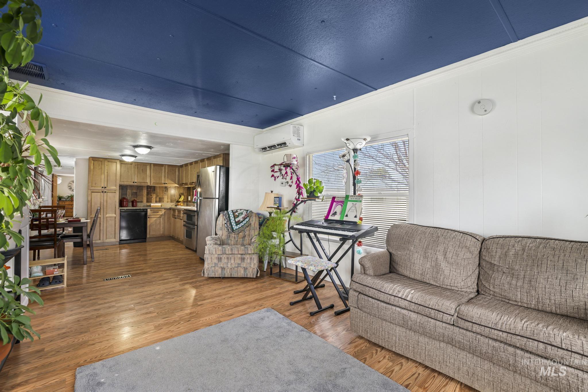 198 South Hills Road, Unit 45 Twin Falls, ID 83301 - Photo 8 of 25 Living room featuring light wood-type flooring and ornamental molding