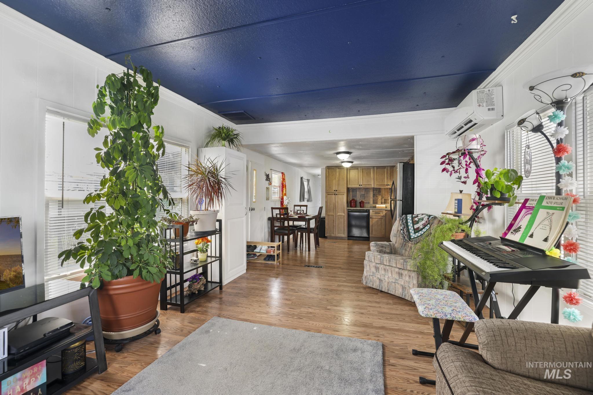 198 South Hills Road, Unit 45 Twin Falls, ID 83301 - Photo 9 of 25 Living area featuring wood finished floors, crown molding, and plenty of natural light