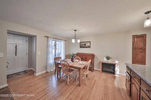 a large kitchen with stainless steel appliances granite countertop a stove a sink dishwasher and cabinets with wooden floor