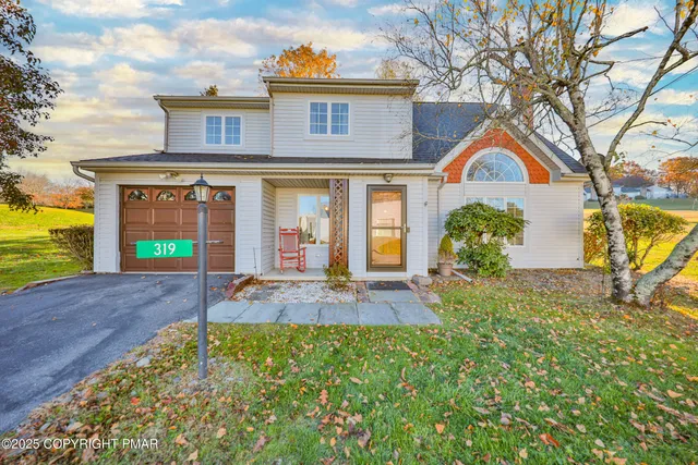 a living room with furniture kitchen view and a wooden floor