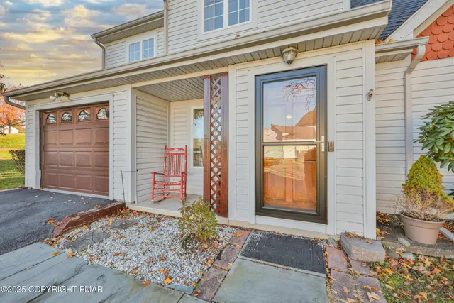 a living room with furniture a fireplace and a large window