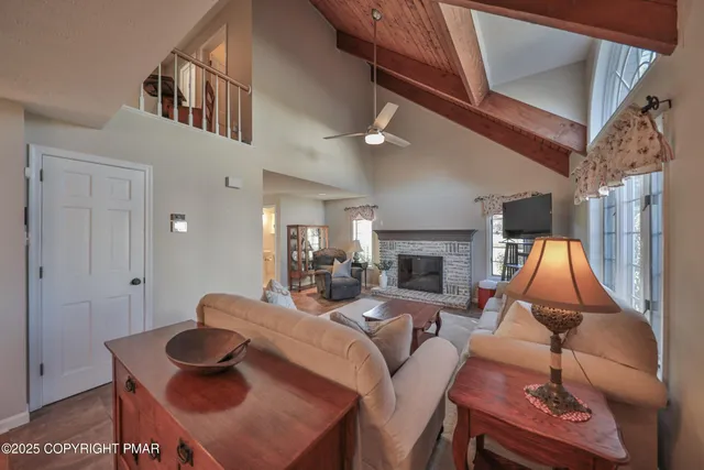 a dining room with wooden floor a chandelier a wooden table and chairs
