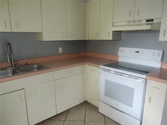 a kitchen with a sink and cabinets