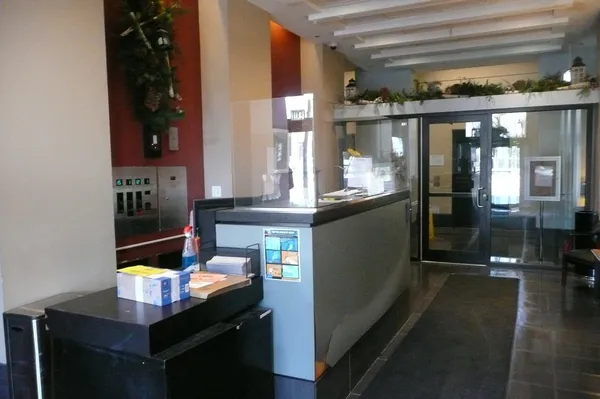 a room with stainless steel appliances kitchen island granite countertop a table and chairs in it