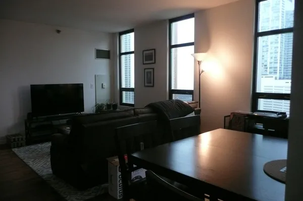 a living room with furniture window and flat screen tv