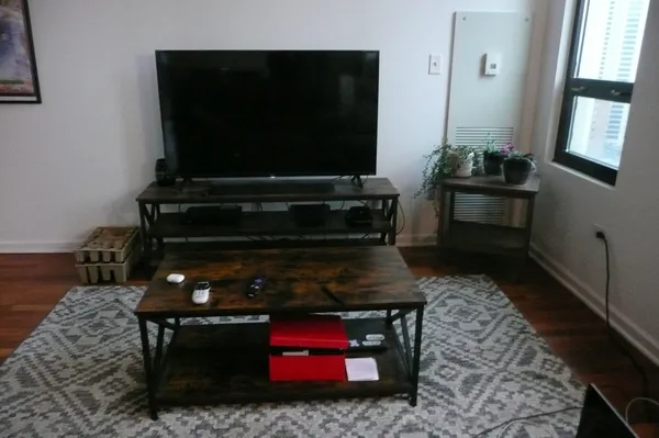 a living room with a fireplace and a flat screen tv