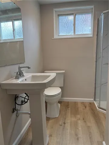 a bathroom with a sink toilet and a mirror
