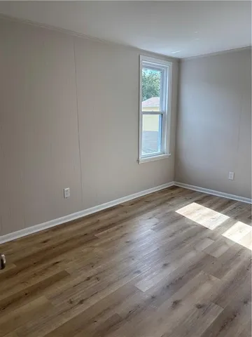 a view of wooden floor and windows in a room
