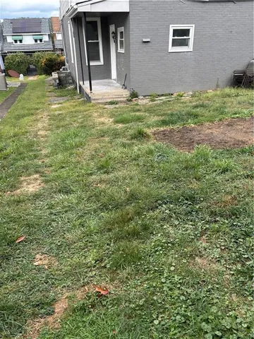 a view of a backyard of the house