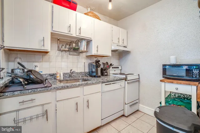 a kitchen with stainless steel appliances granite countertop a sink dishwasher stove and cabinets