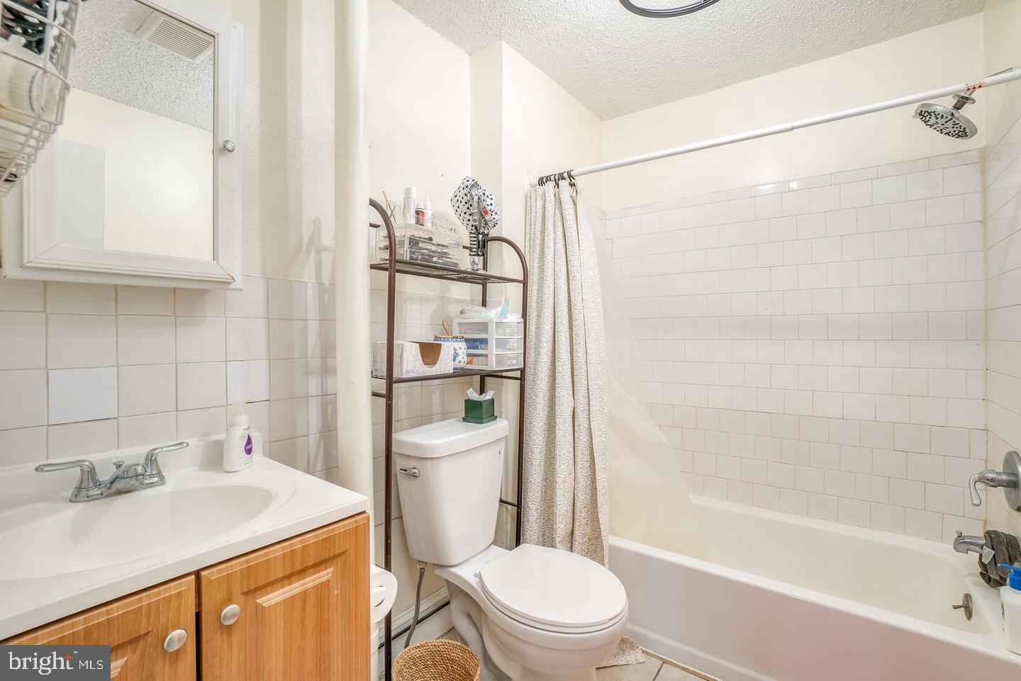 1420 Light Street, Unit 3F Baltimore, MD 21230 - Photo 6 of 8 a bathroom with a sink a toilet and shower