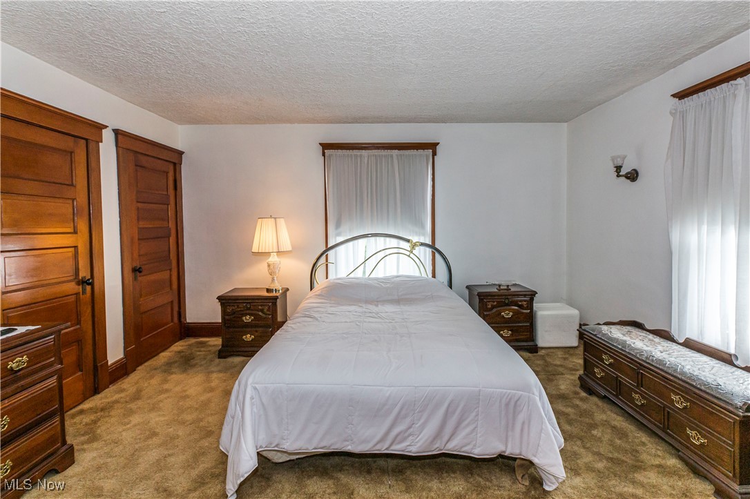 749 Amherst Road Northeast Massillon, OH 44646 - Photo 32 of 41 Carpeted bedroom with a textured ceiling
