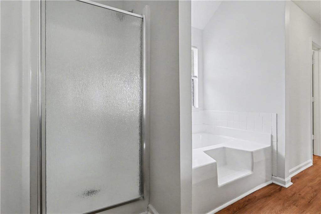 6236 Springwater Lane Lithonia, GA 30058 - Photo 16 of 23 a bathroom with a glass shower door