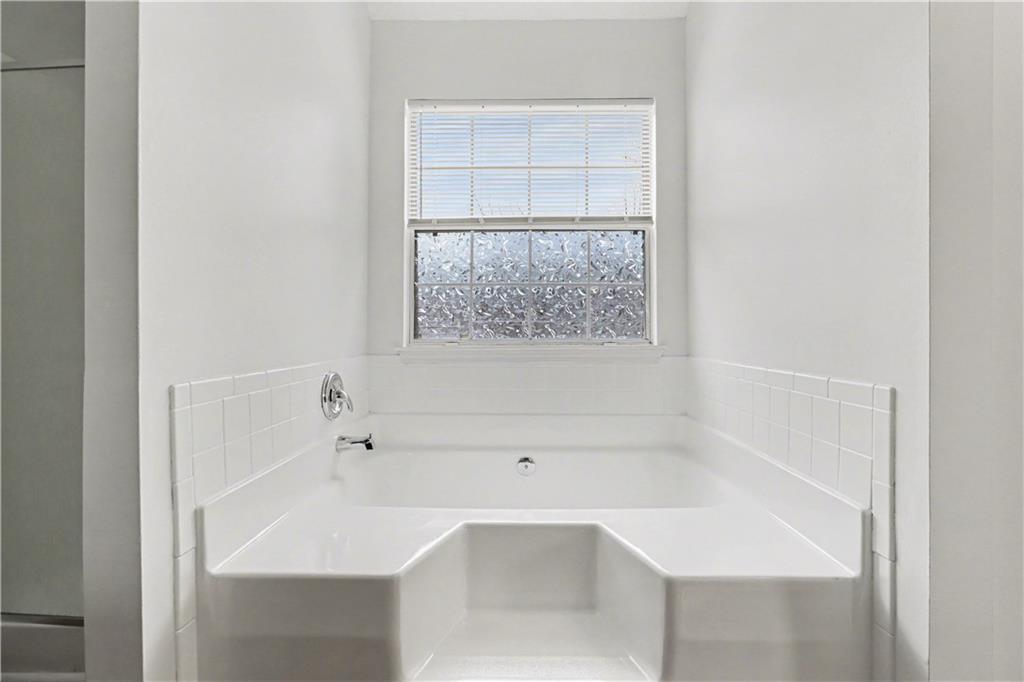 6236 Springwater Lane Lithonia, GA 30058 - Photo 17 of 23 a white bath tub sitting next to a white sink