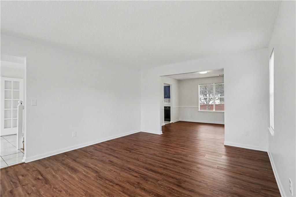 6236 Springwater Lane Lithonia, GA 30058 - Photo 5 of 23 a view of empty room with wooden floor and window