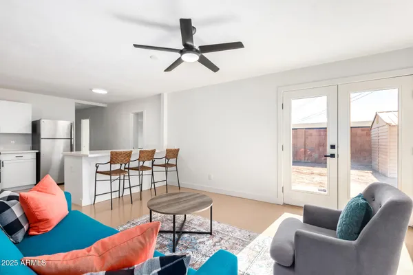 a living room with furniture and a wooden floor