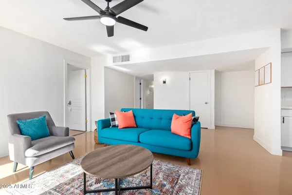 a living room with furniture and a rug