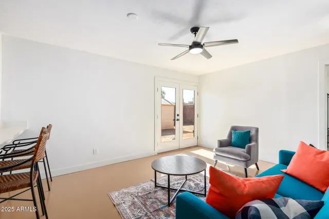 a living room with furniture a rug and a window