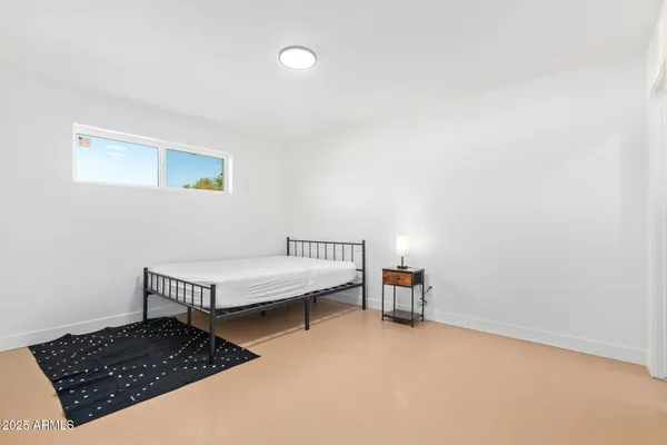 a bedroom with a bed and a window