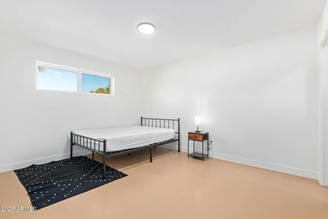 a bedroom with a bed and a window