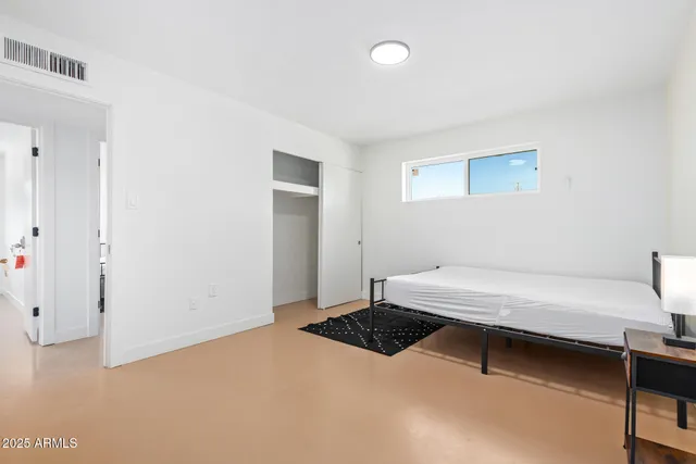 a bedroom with a bed and a table