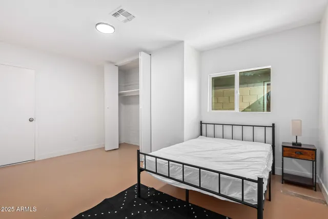 a bedroom with a bed and a window