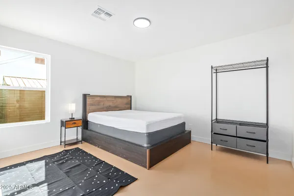 a bedroom with a bed and window