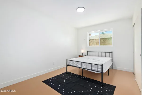 a bedroom with a bed and a window