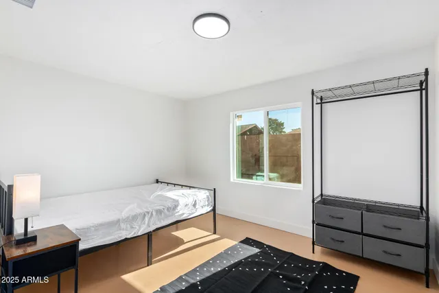 a bedroom with a bed and a window