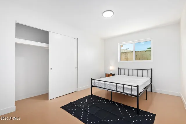 a bedroom with a bed and a window