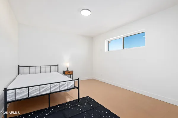 a bedroom with a bed and a table