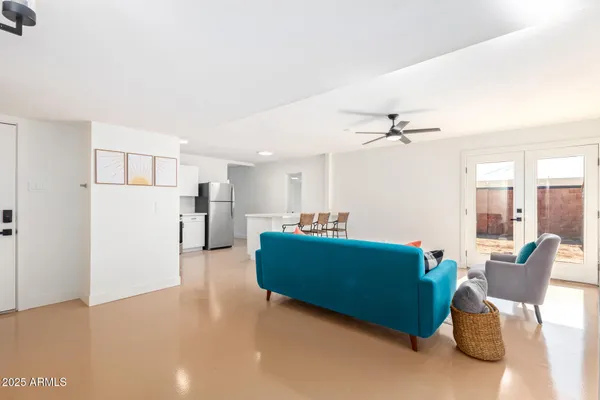 a living room with furniture and a kitchen view