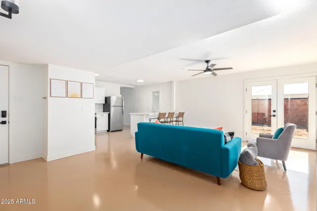 a living room with furniture and a kitchen view