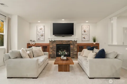 a living room with furniture kitchen and a large window