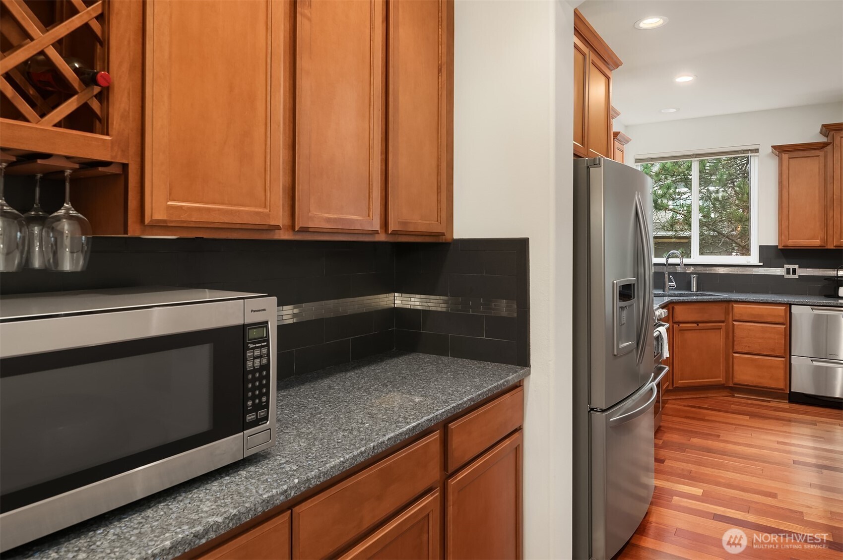787 Hoquiam Place Northeast Renton, WA 98059 - Photo 22 of 36 a kitchen with granite countertop a stove a sink and a microwave