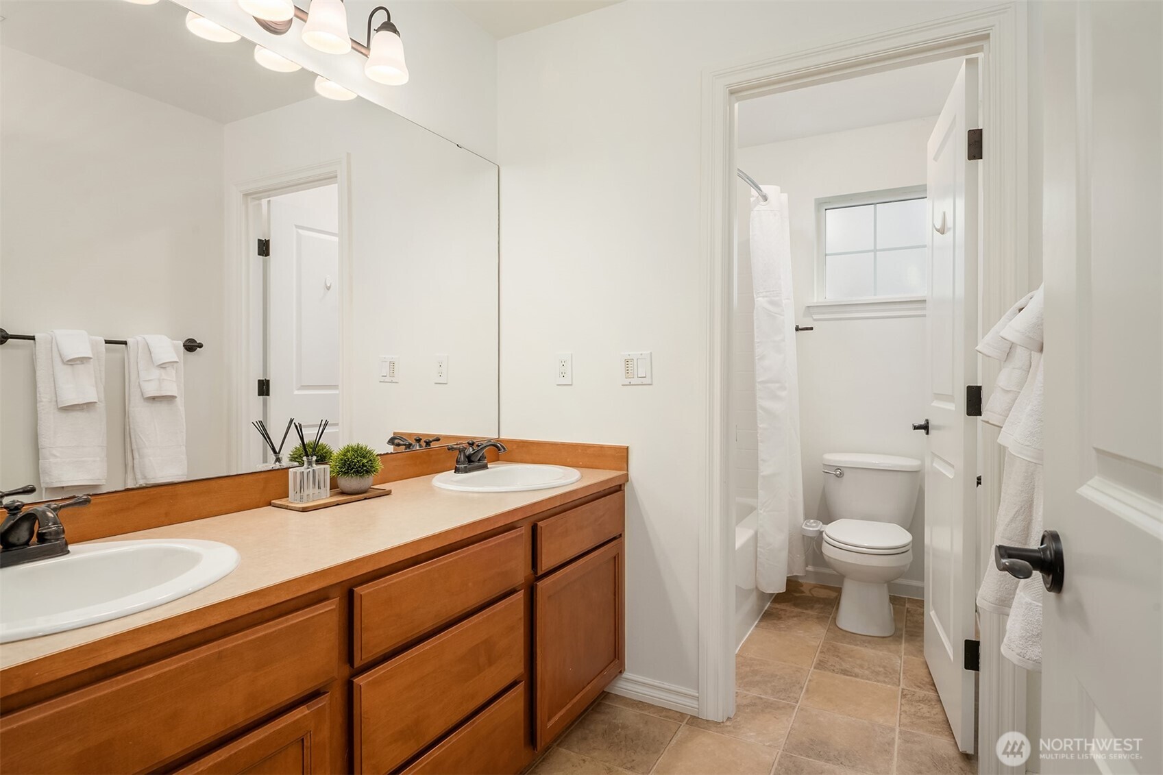787 Hoquiam Place Northeast Renton, WA 98059 - Photo 30 of 36 a bathroom with a sink a toilet and shower
