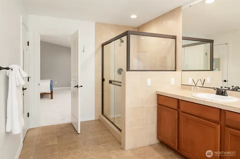 a large white kitchen with kitchen island a sink a stove and a refrigerator