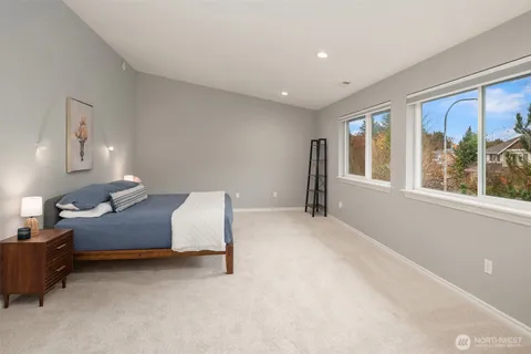 a spacious bedroom with a bed and a fireplace