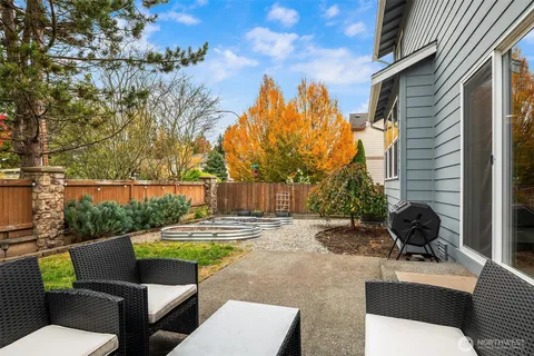 a view of a backyard with sitting area and garden