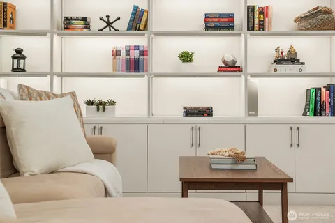 a living room with white cabinets and couch